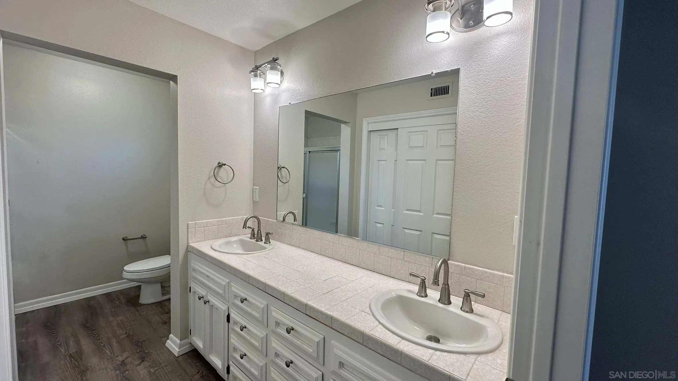 16142 Dartolo Road Ramona, CA 92065 - Photo 14 of 31 a bathroom with a sink double vanity and a toilet