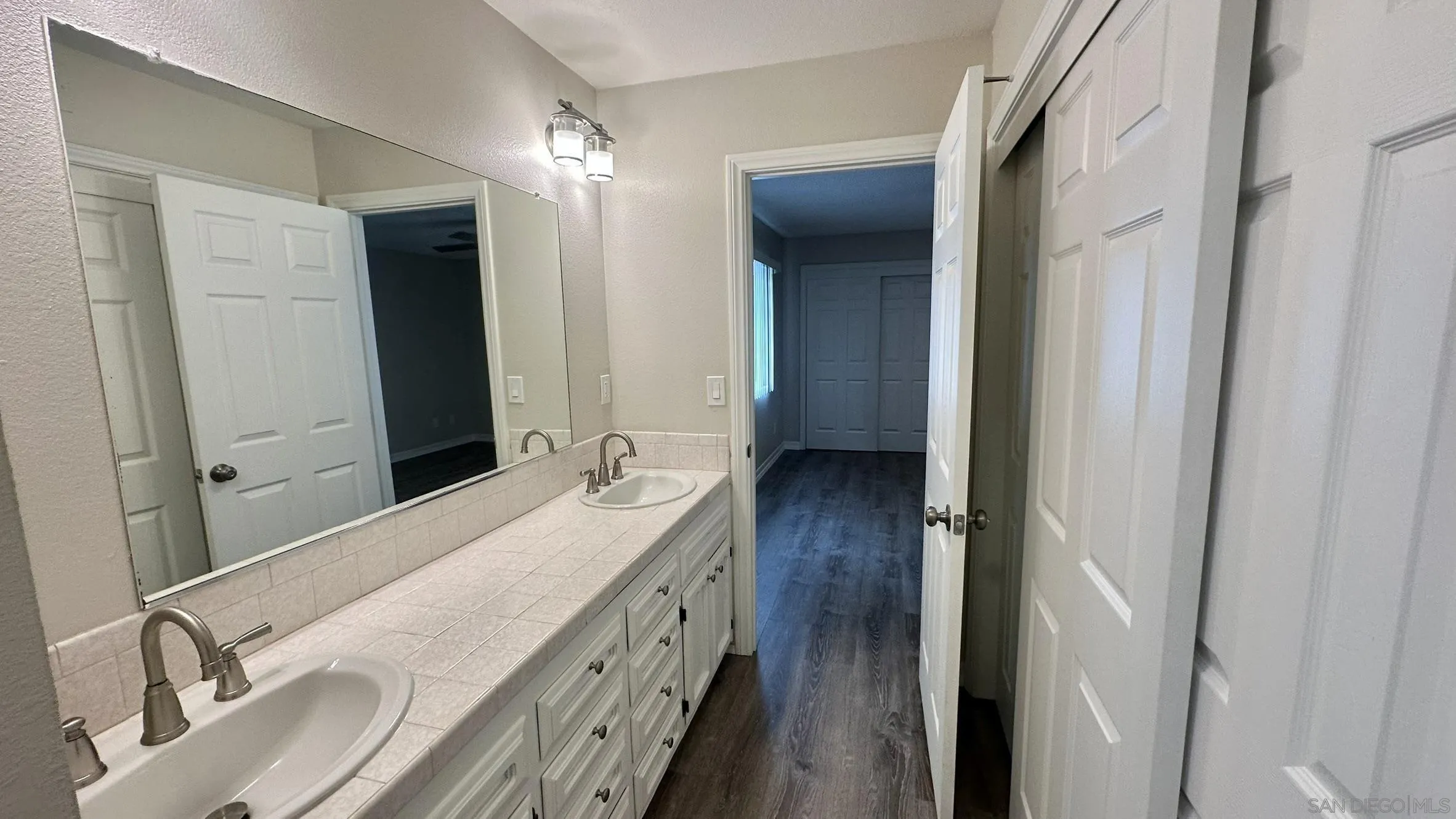 16142 Dartolo Road Ramona, CA 92065 - Photo 15 of 31 a en suite bathroom with a double vanity sink and a mirror