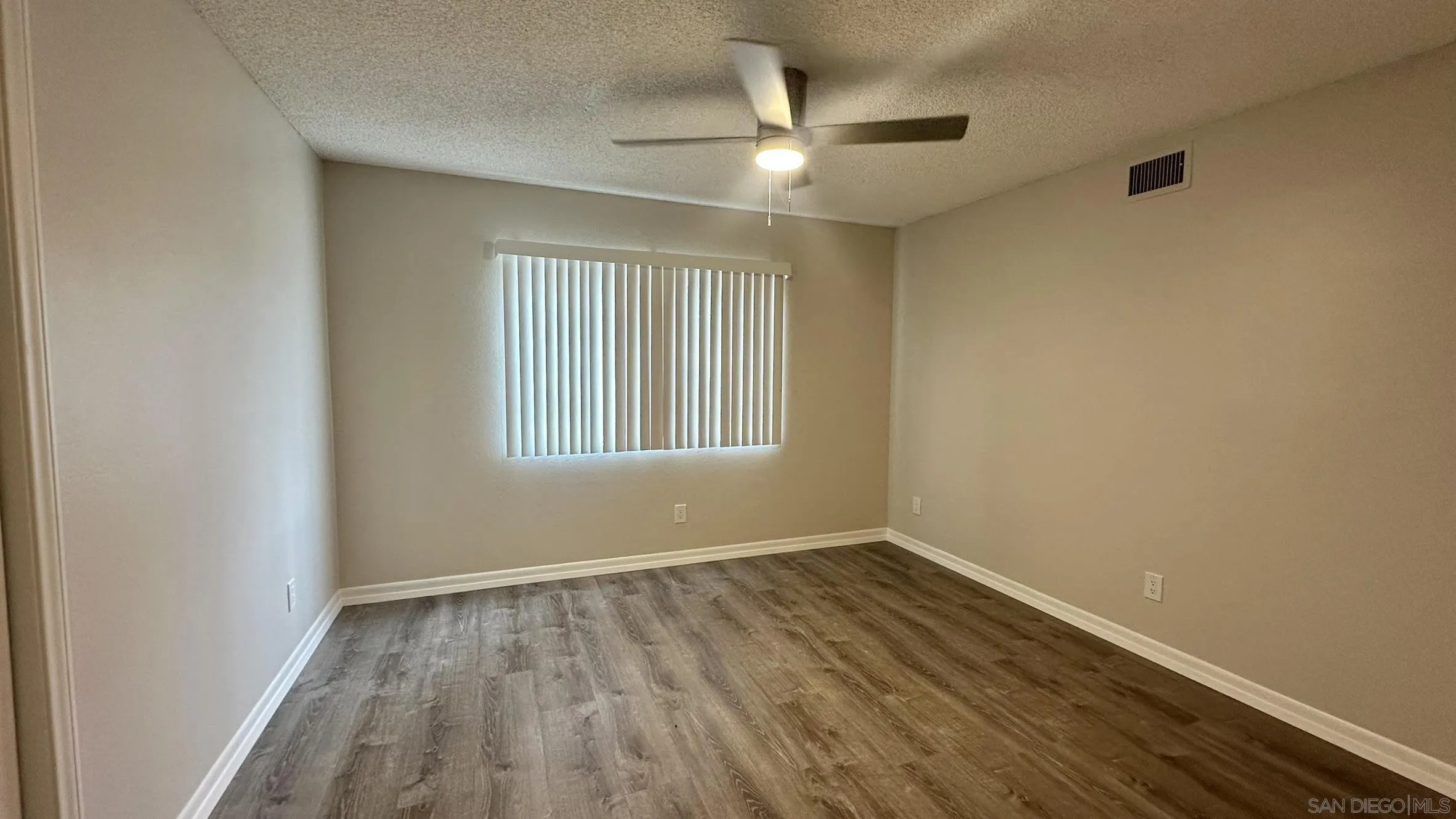 16142 Dartolo Road Ramona, CA 92065 - Photo 16 of 31 wooden floor in an empty room with a window