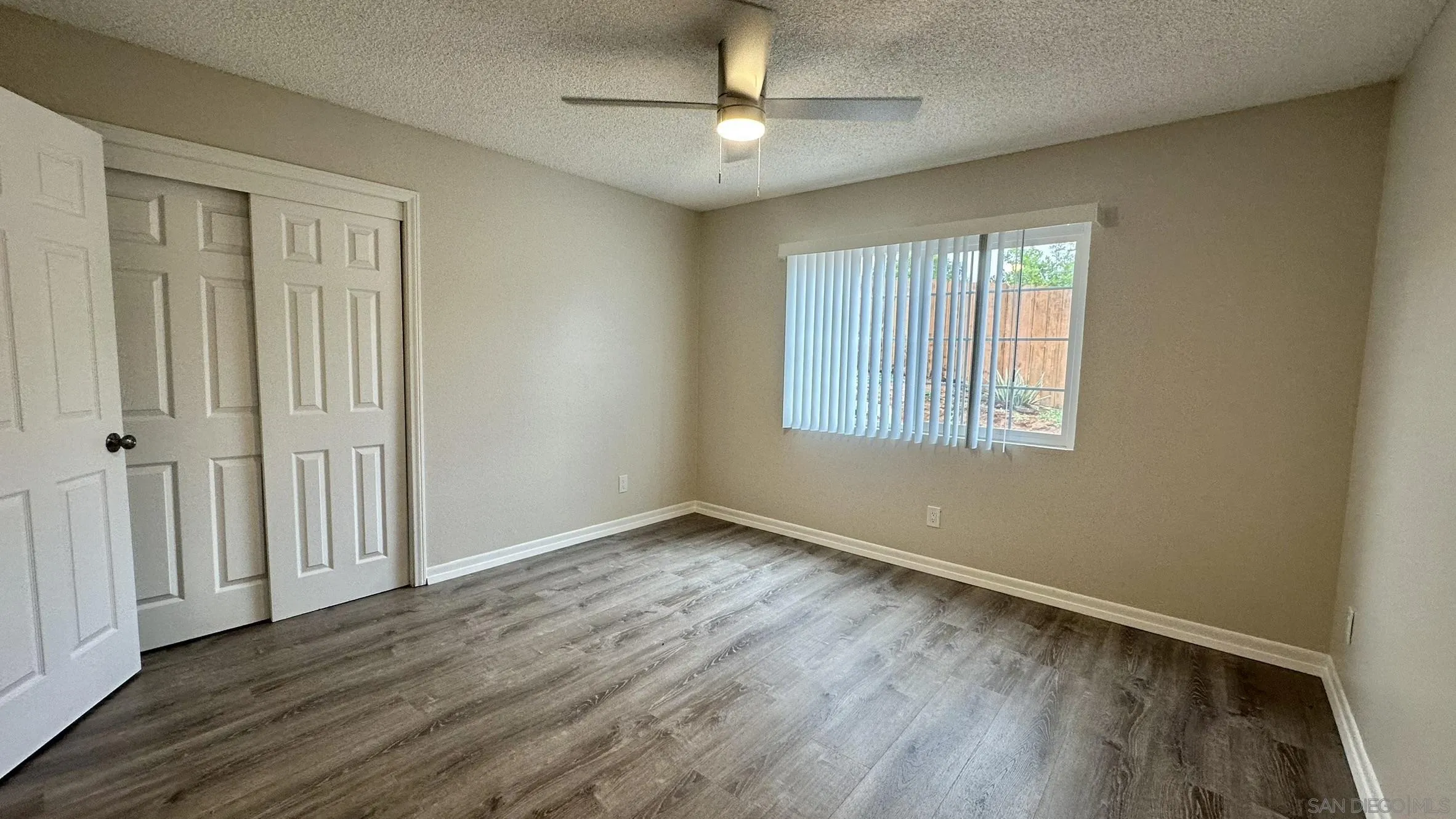 16142 Dartolo Road Ramona, CA 92065 - Photo 17 of 31 wooden floor in an empty room with a window