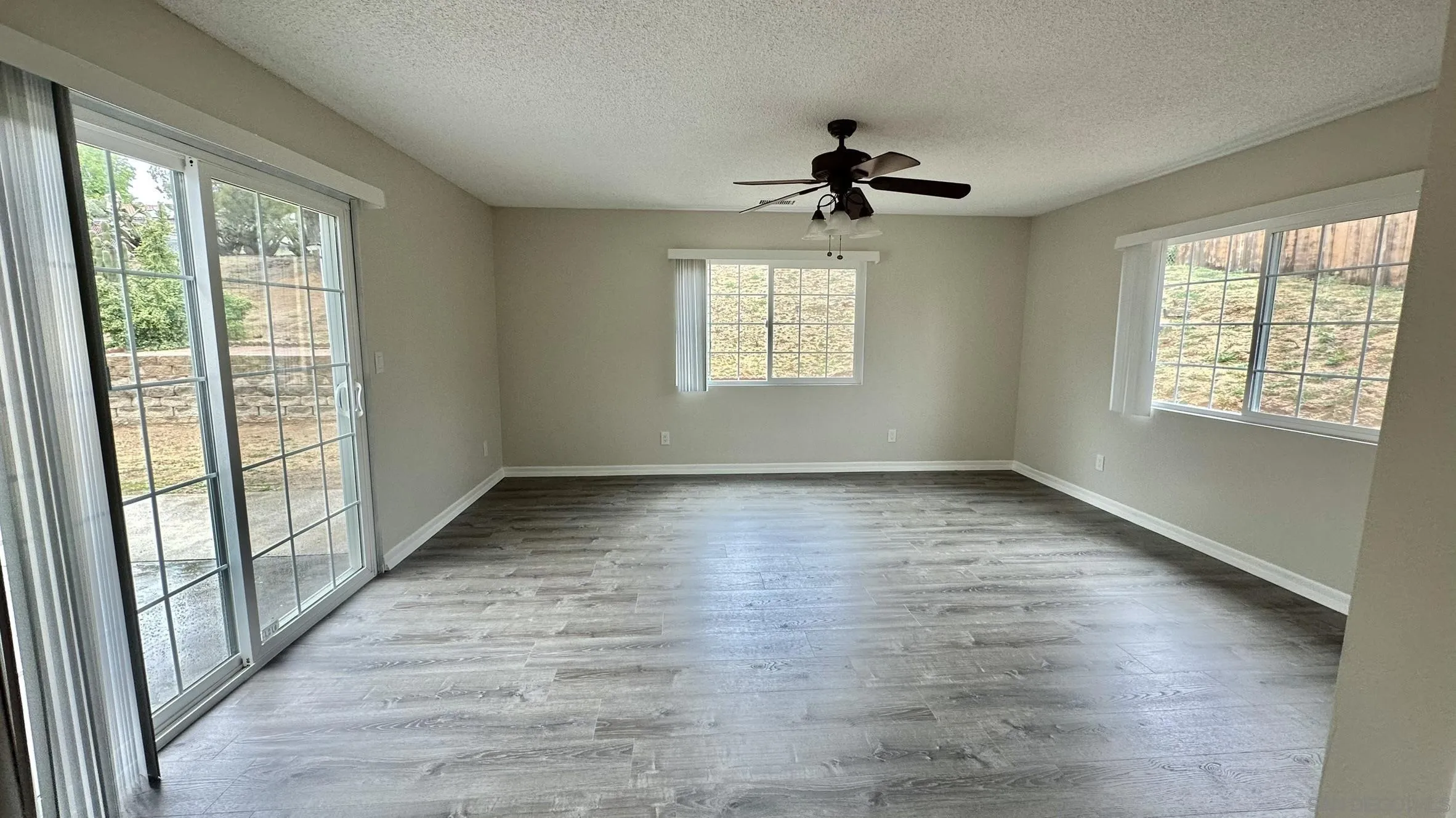 16142 Dartolo Road Ramona, CA 92065 - Photo 19 of 31 wooden floor in an empty room with a window