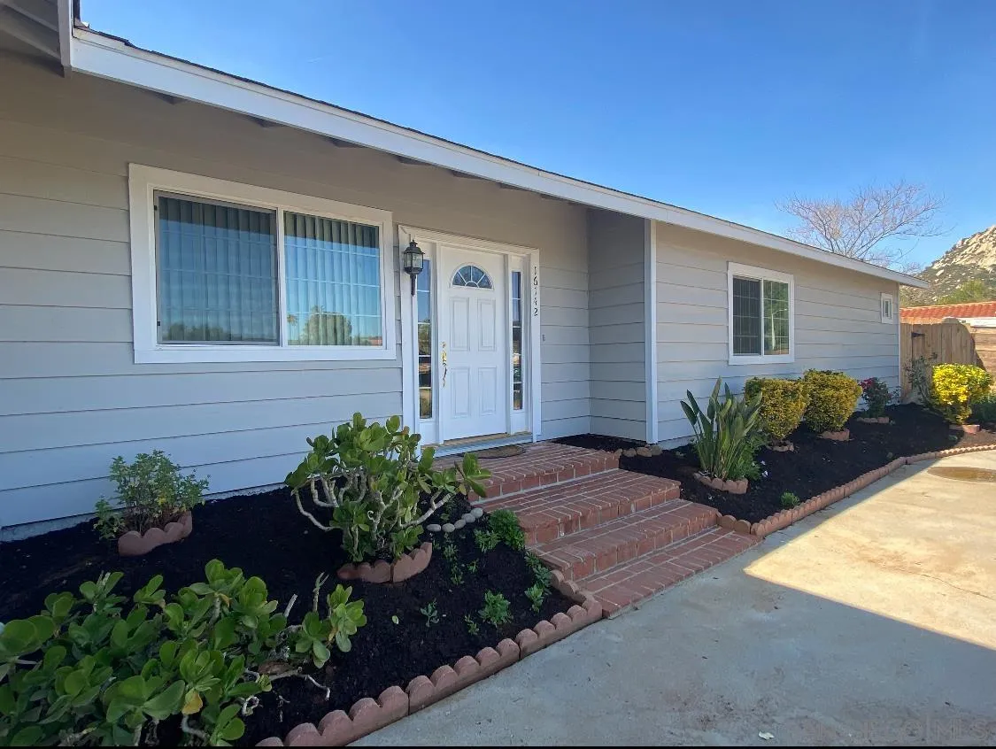 16142 Dartolo Road Ramona, CA 92065 - Photo 2 of 31 a front view of a house with potted plants
