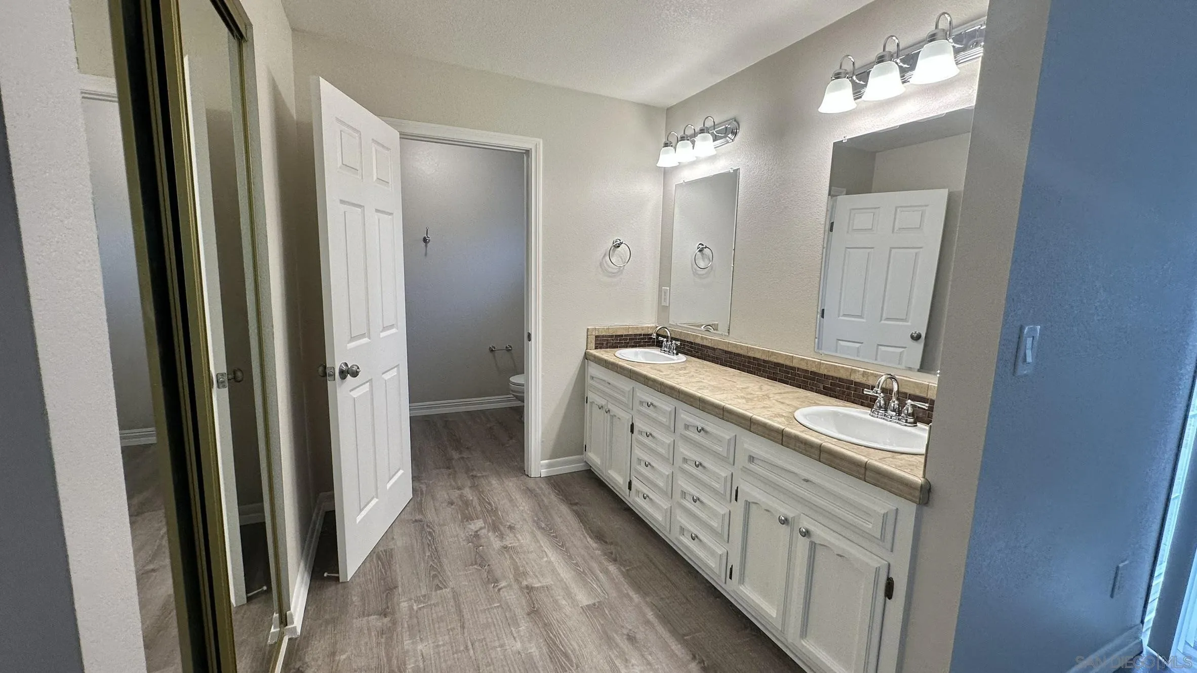 16142 Dartolo Road Ramona, CA 92065 - Photo 25 of 31 a bathroom with a double vanity sink and mirror