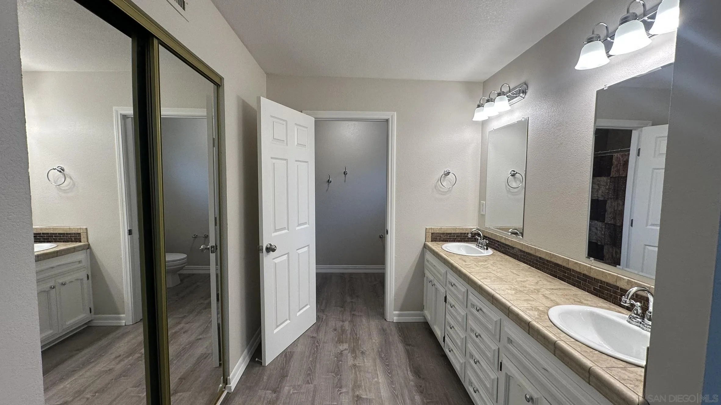 16142 Dartolo Road Ramona, CA 92065 - Photo 26 of 31 a bathroom with a double vanity sink and a mirror