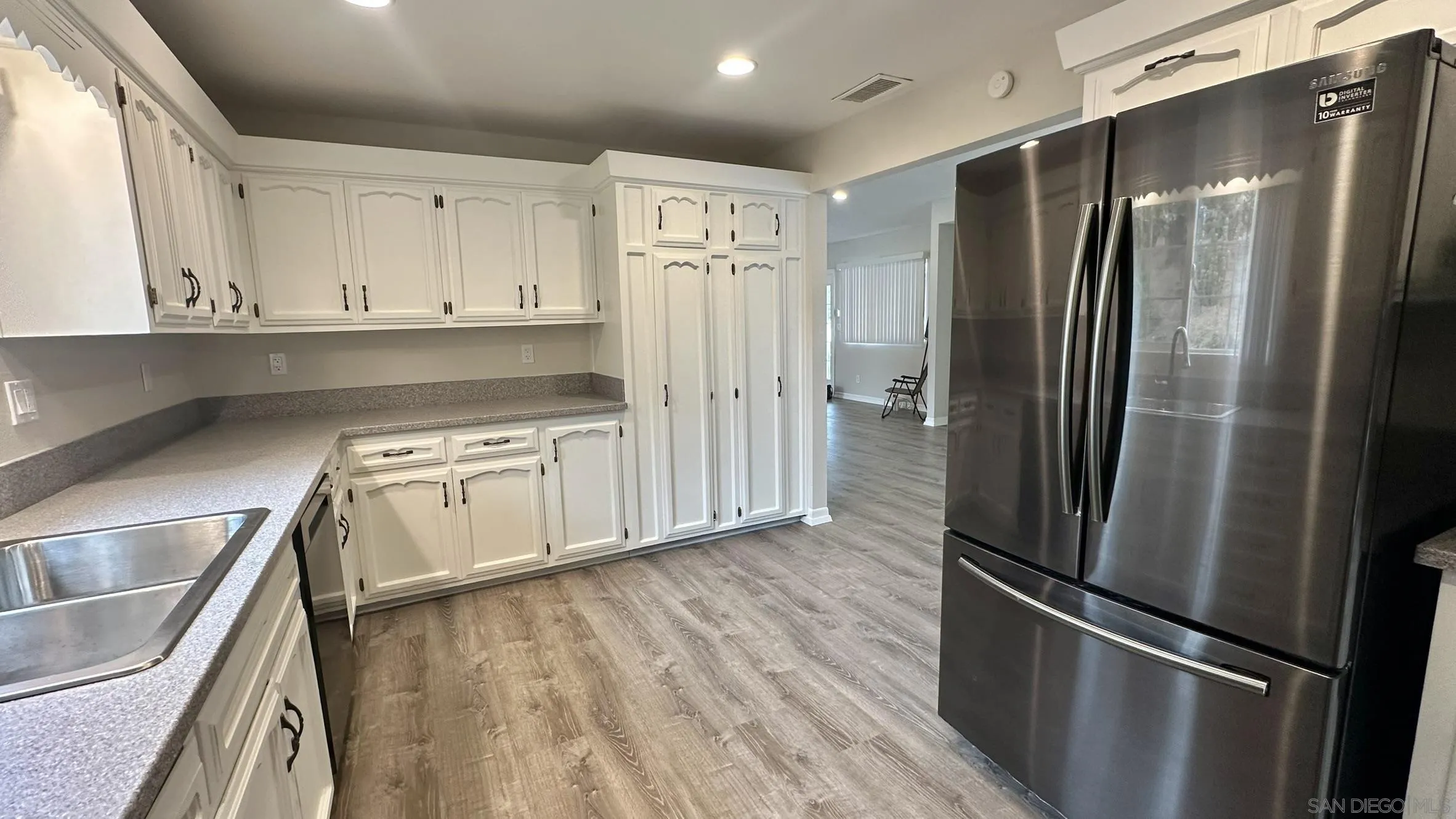 16142 Dartolo Road Ramona, CA 92065 - Photo 9 of 31 a kitchen with stainless steel appliances granite countertop a refrigerator and a stove top oven