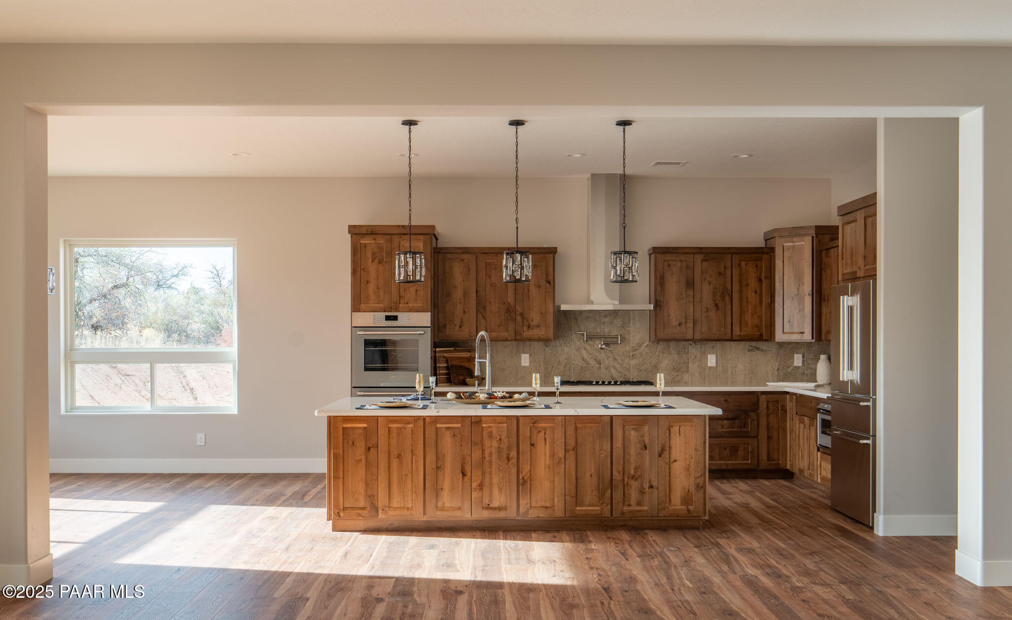 9596 North Bridle Ridge Road Prescott, AZ 86305 - Photo 16 of 58 a kitchen with kitchen island granite countertop a sink a counter top space and cabinets