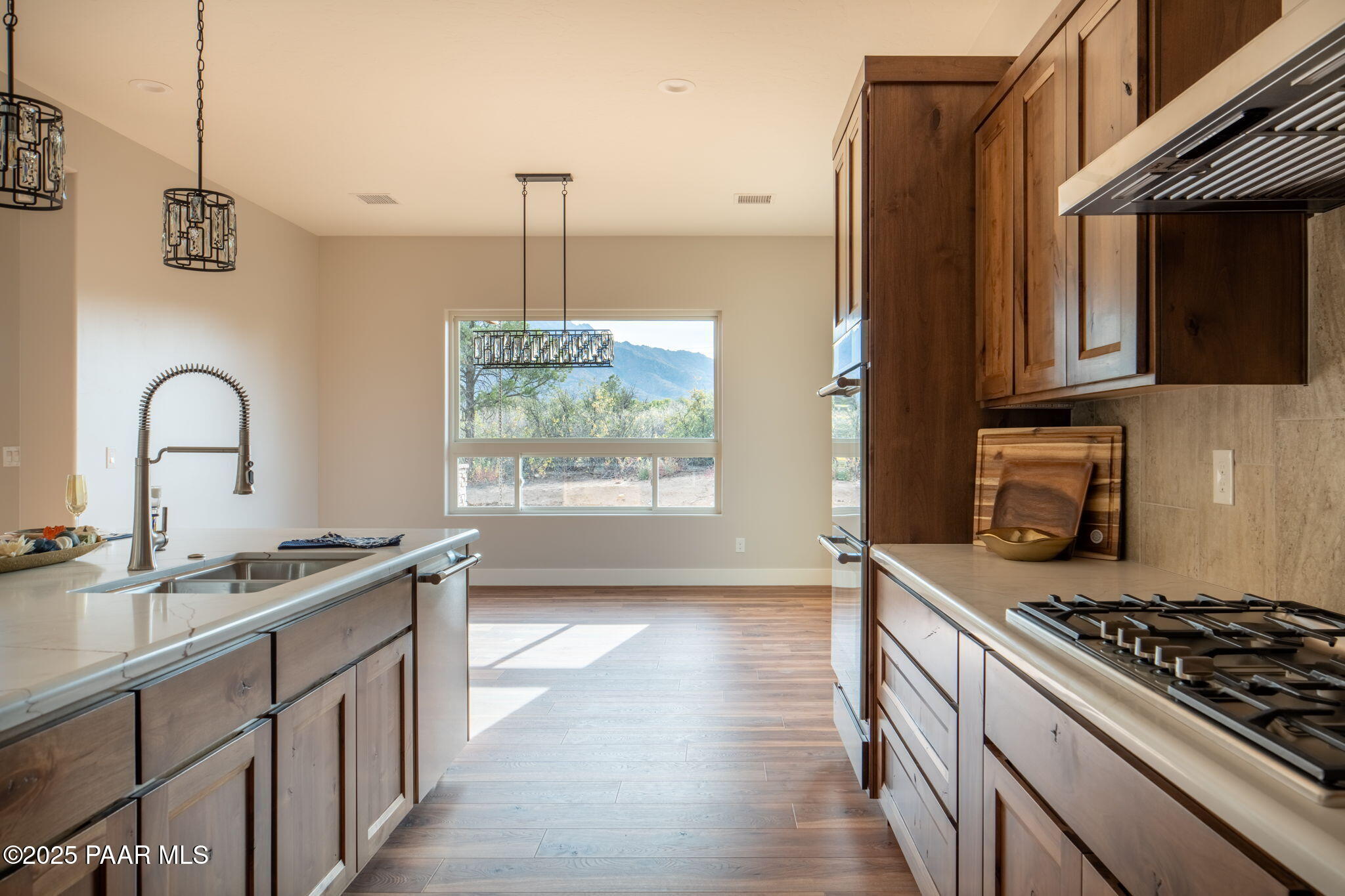 9596 North Bridle Ridge Road Prescott, AZ 86305 - Photo 18 of 58 a kitchen with stainless steel appliances granite countertop a sink stove and cabinets