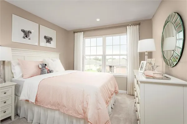 a bedroom with a bed a large window with outer view and mirror