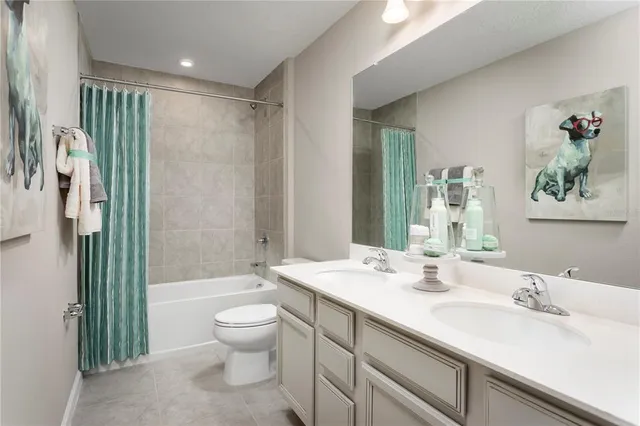 a bathroom with a double vanity sink toilet and shower