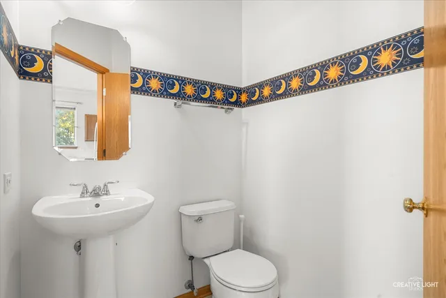 a bathroom with a sink a mirror and a toilet