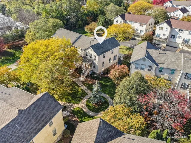 an aerial view of a house with a yard basket ball court and outdoor seating