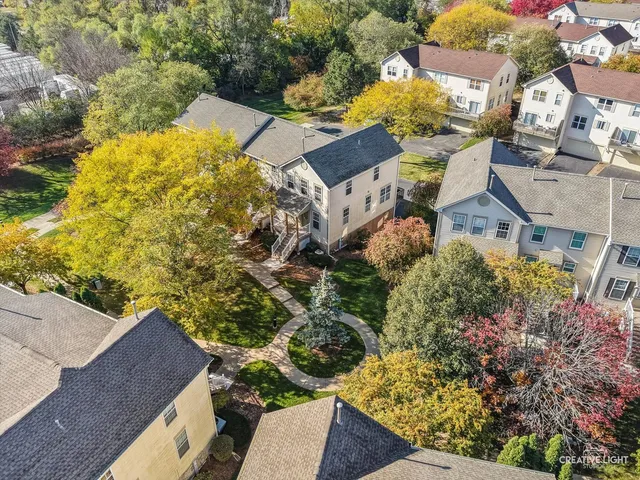 an aerial view of residential houses with outdoor space