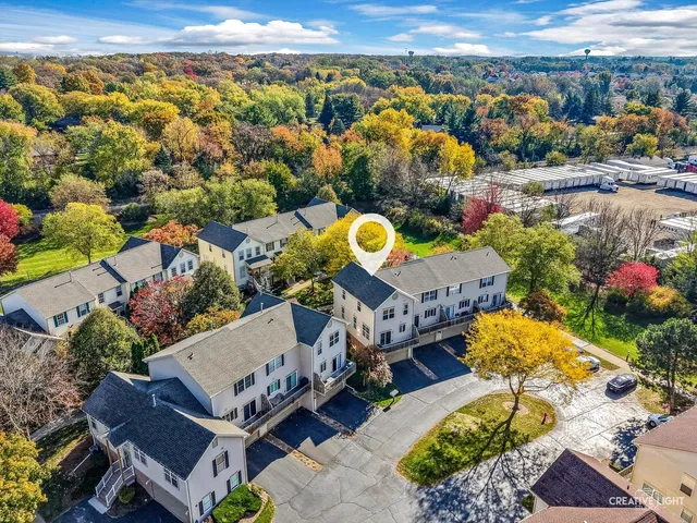 an aerial view of a house with a swimming pool yard and outdoor seating