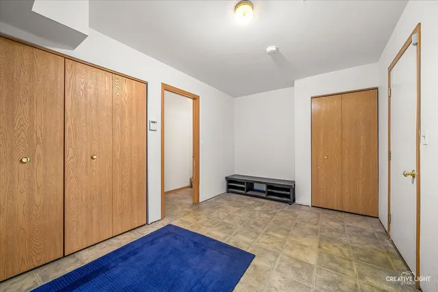 an empty room with wooden floor and a window