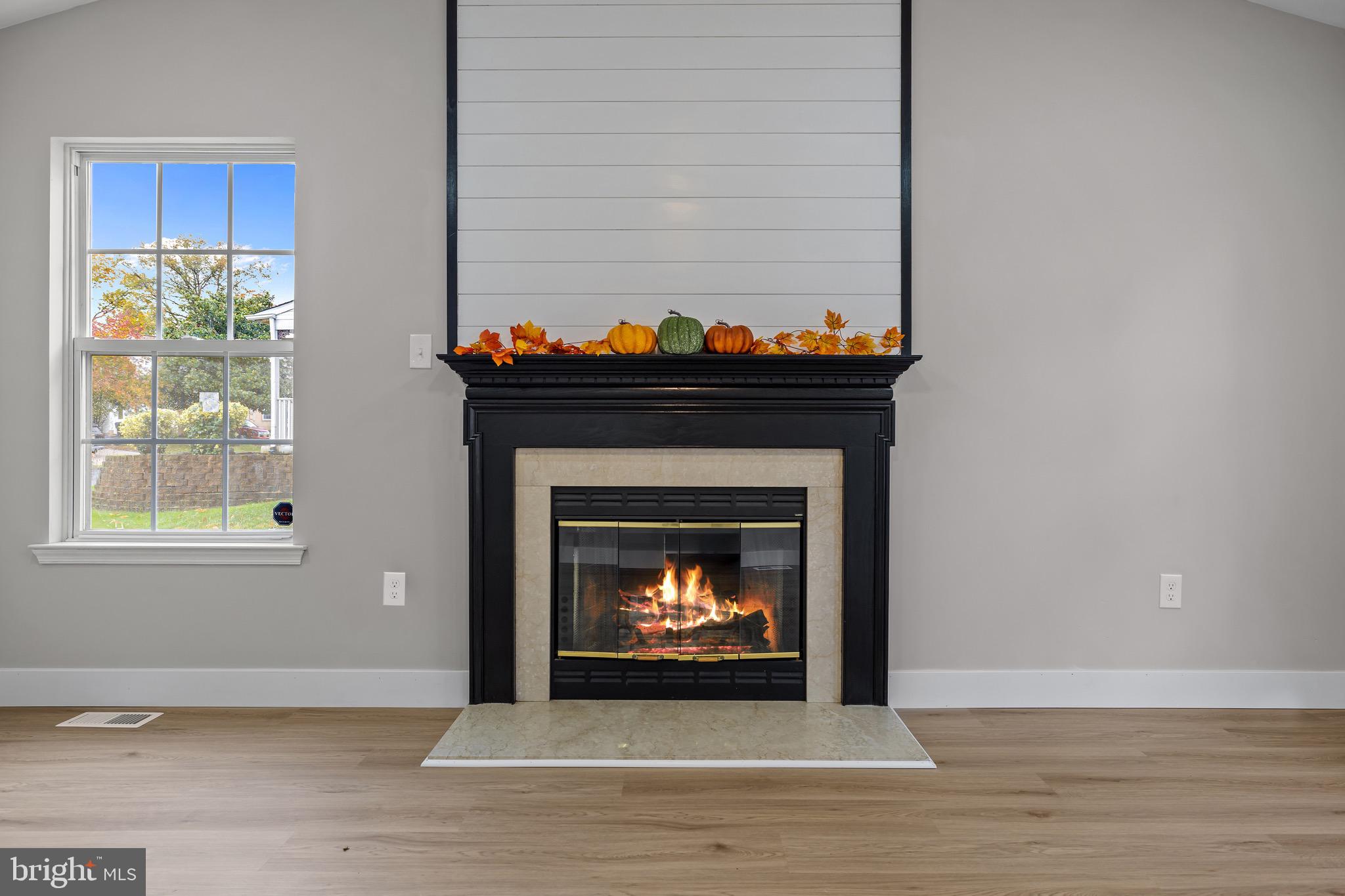 81 Rosalind Circle Sicklerville, NJ 08081 - Photo 12 of 21 a living room with a fireplace and a wooden floor