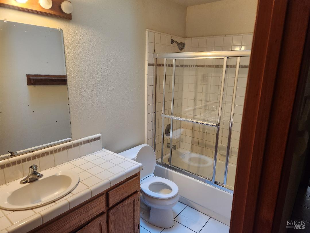 466 Walten Way Windsor, CA 95492 - Photo 3 of 7 a bathroom with a granite countertop sink toilet and shower