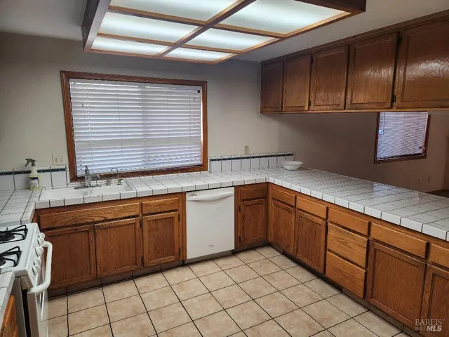 a kitchen with stainless steel appliances granite countertop a sink and cabinets