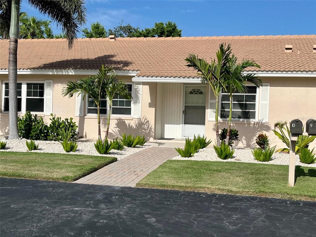 540 Neptune Avenue, Unit 7 Longboat Key, FL 34228 - Photo 1 of 12 a front view of a house with garden