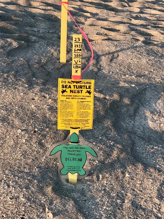 540 Neptune Avenue, Unit 7 Longboat Key, FL 34228 - Photo 9 of 12 a sign that is on a brick wall