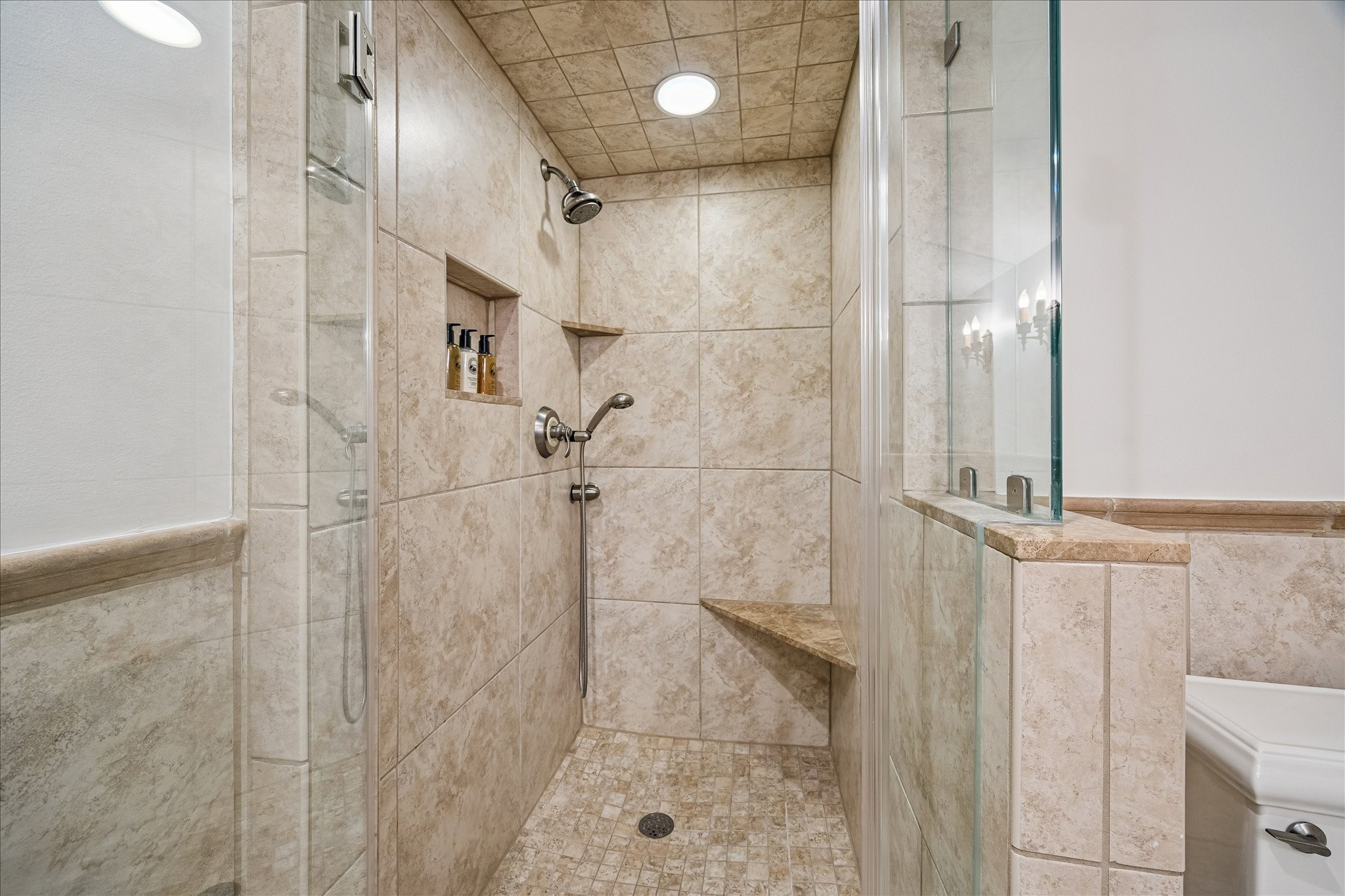 2368 Timber Lane Houston, TX 77027 - Photo 41 of 46 The en suite bath is appointed with a frameless glass walk-in shower, separate handheld sprayer, granite countertops, and refined brushed metal fixtures.