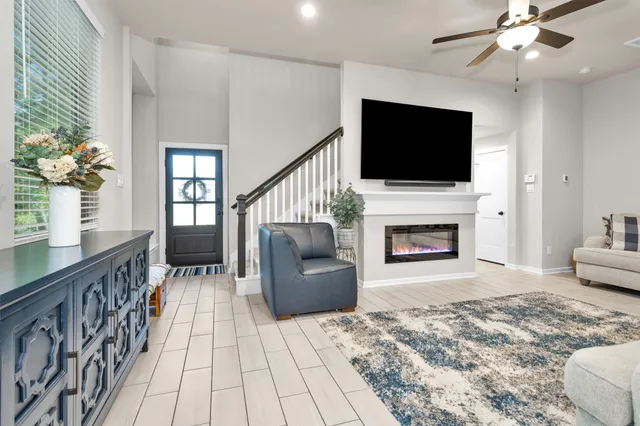 a living room with furniture fireplace and flat screen tv
