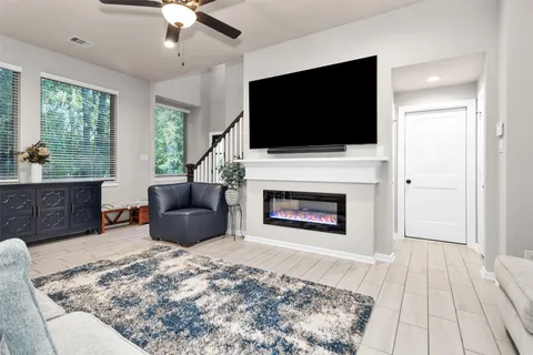 a kitchen with stainless steel appliances kitchen island granite countertop a refrigerator a stove a sink and a dining table with white cabinets