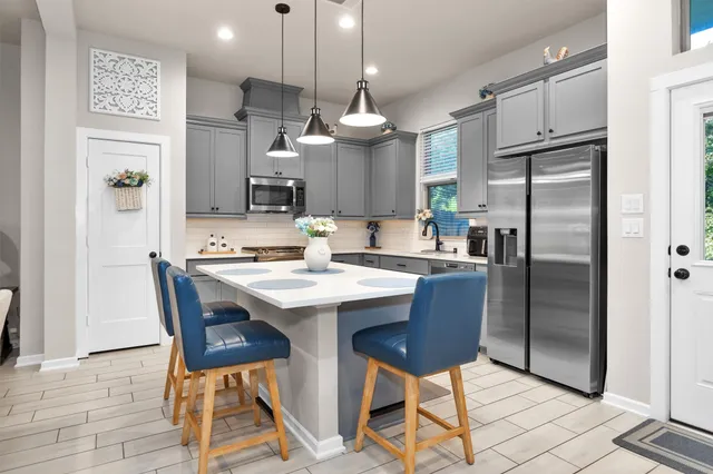 a kitchen with a stove a sink and a microwave