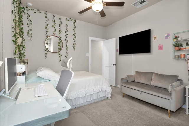 a bedroom with a bed and a couch