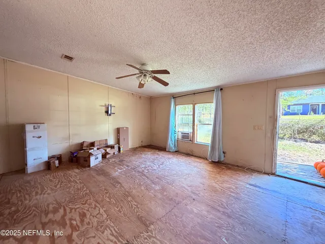 a view of a livingroom with furniture and a window