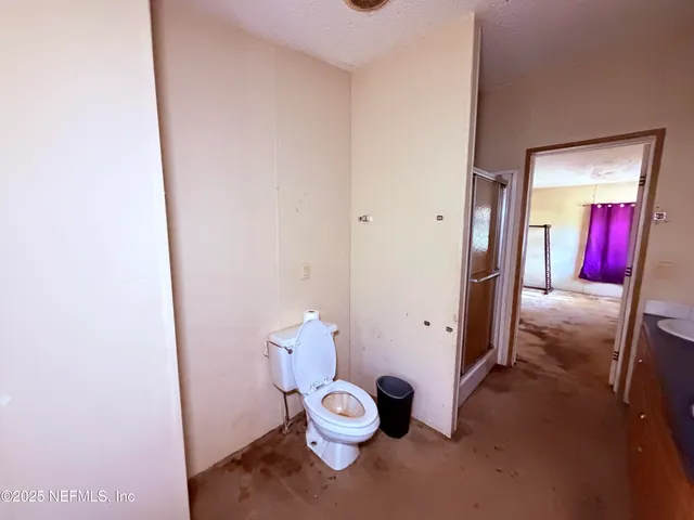 an empty room with closet and windows