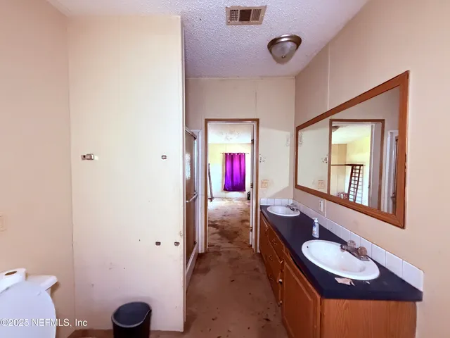 a view of a hallway with furniture and window