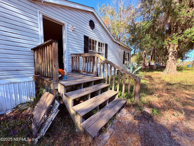 a view of a wooden chairs on the deck
