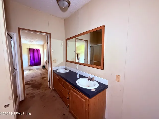 a living room with a table and chandelier