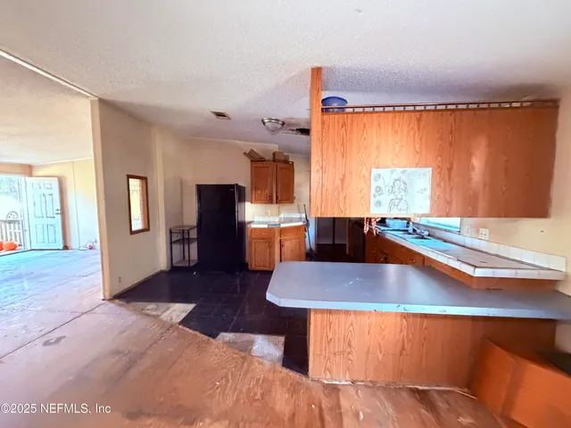 a view of a sink a table and chairs in a room