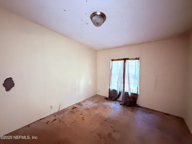 a view of a large yard with lots of bushes