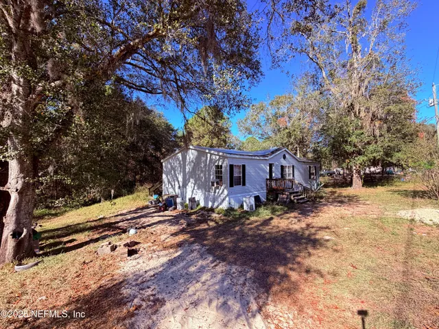 a view of a house with a yard covered with snow