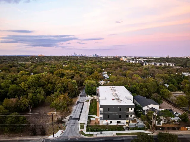 a view of a big room with a lots of buildings in the background
