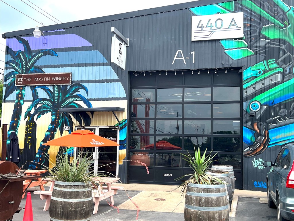 5515 Humming Bird Lane, Unit 207 Austin, TX 78745 - Photo 23 of 32 a front view of a house with yard and outdoor seating