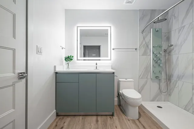 a kitchen with stainless steel appliances a refrigerator sink and microwave