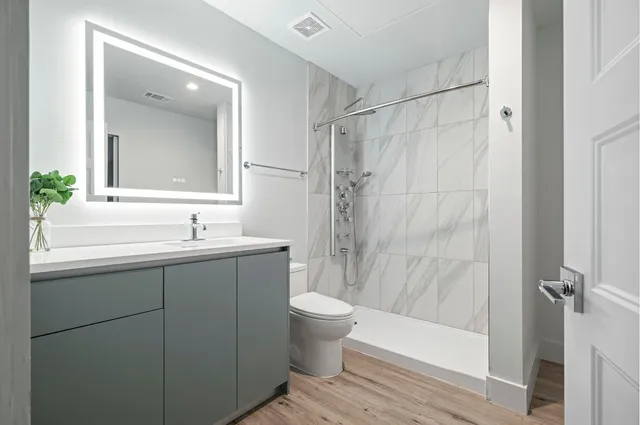 a bathroom with a sink toilet and shower