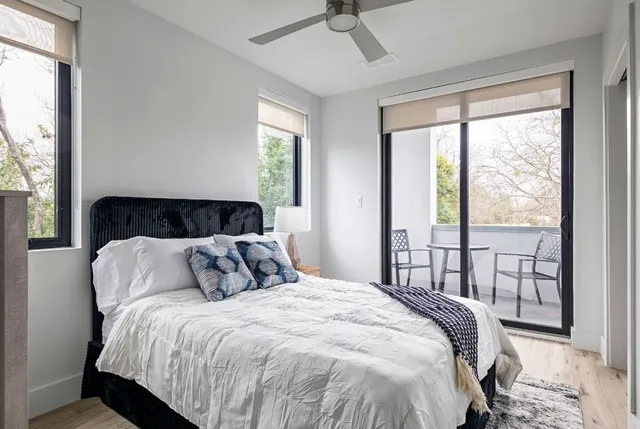 a bedroom with a bed and a large window