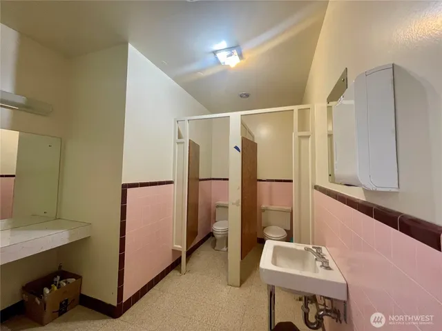 a kitchen with a stove a refrigerator and cabinets