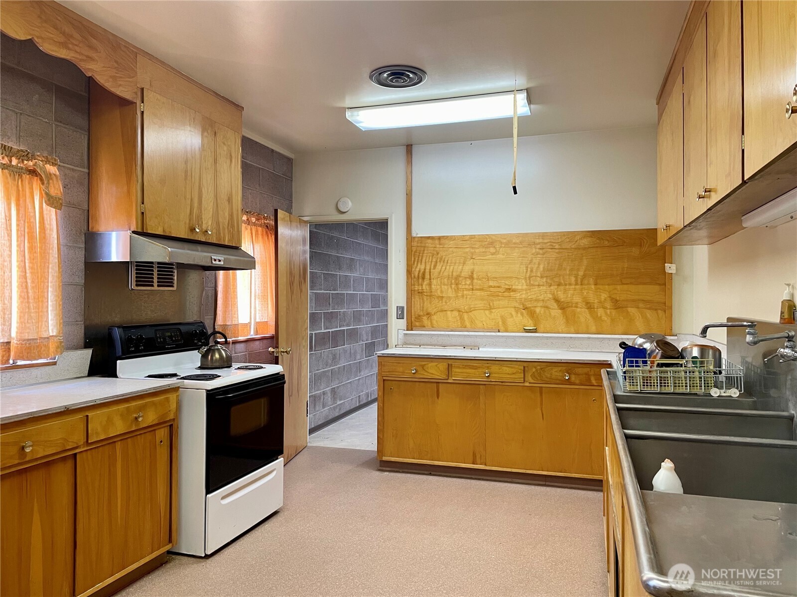 138 Range Street Hartline, WA 99135 - Photo 25 of 34 a kitchen with stainless steel appliances a stove a sink and a refrigerator