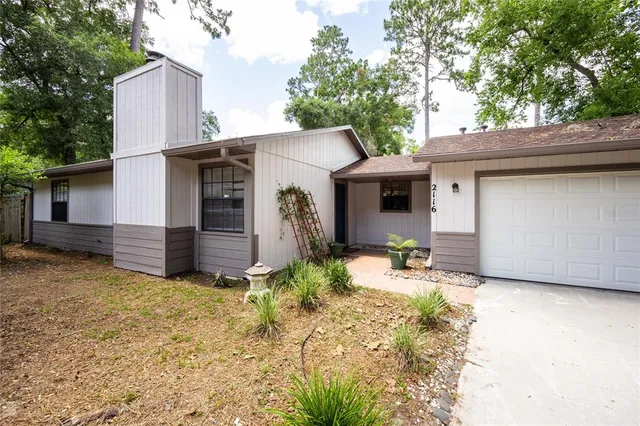 a view of a house with a yard and garage