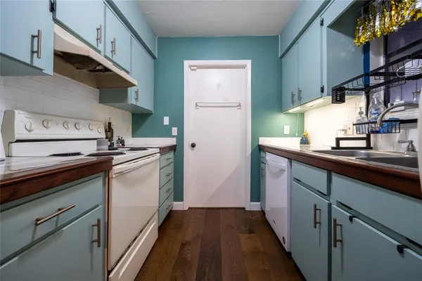 a kitchen with stainless steel appliances granite countertop a sink and a stove