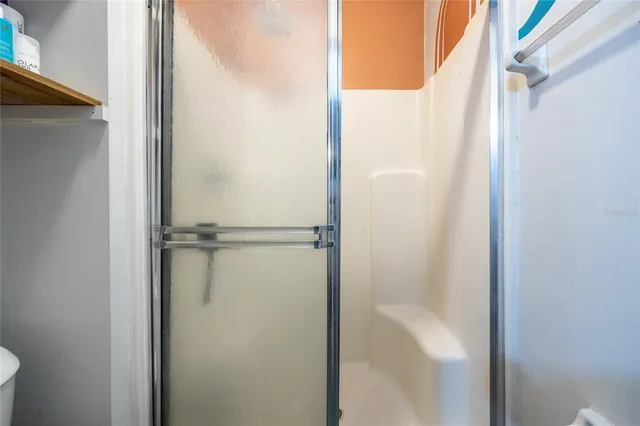 a bathroom with a glass shower door