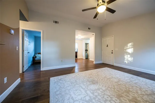 a view of a livingroom with a chandelier fan and a bathroom