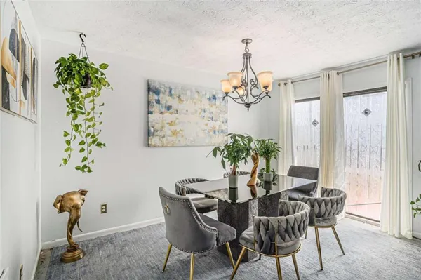 a view of a dining room with furniture and chandelier