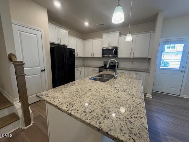 448 Glen Clova Drive Raleigh, NC 27603 - Photo 6 of 23 a kitchen with a refrigerator a sink a stove a microwave and cabinets