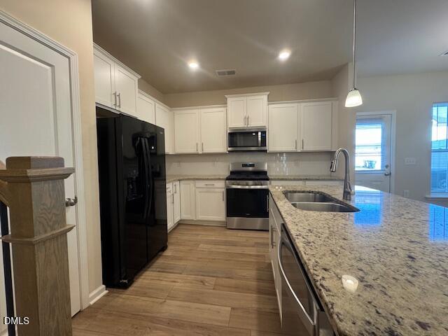 448 Glen Clova Drive Raleigh, NC 27603 - Photo 7 of 23 a large kitchen with stainless steel appliances granite countertop a refrigerator a stove and a sink